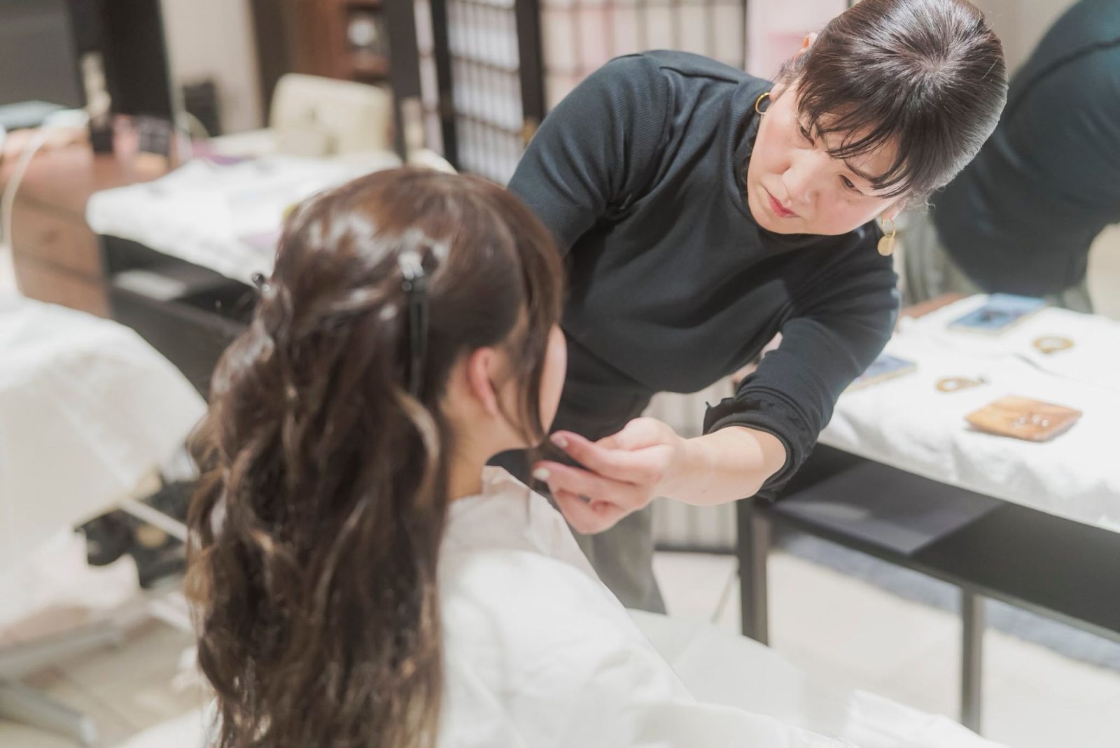 Reina styling a client's hair